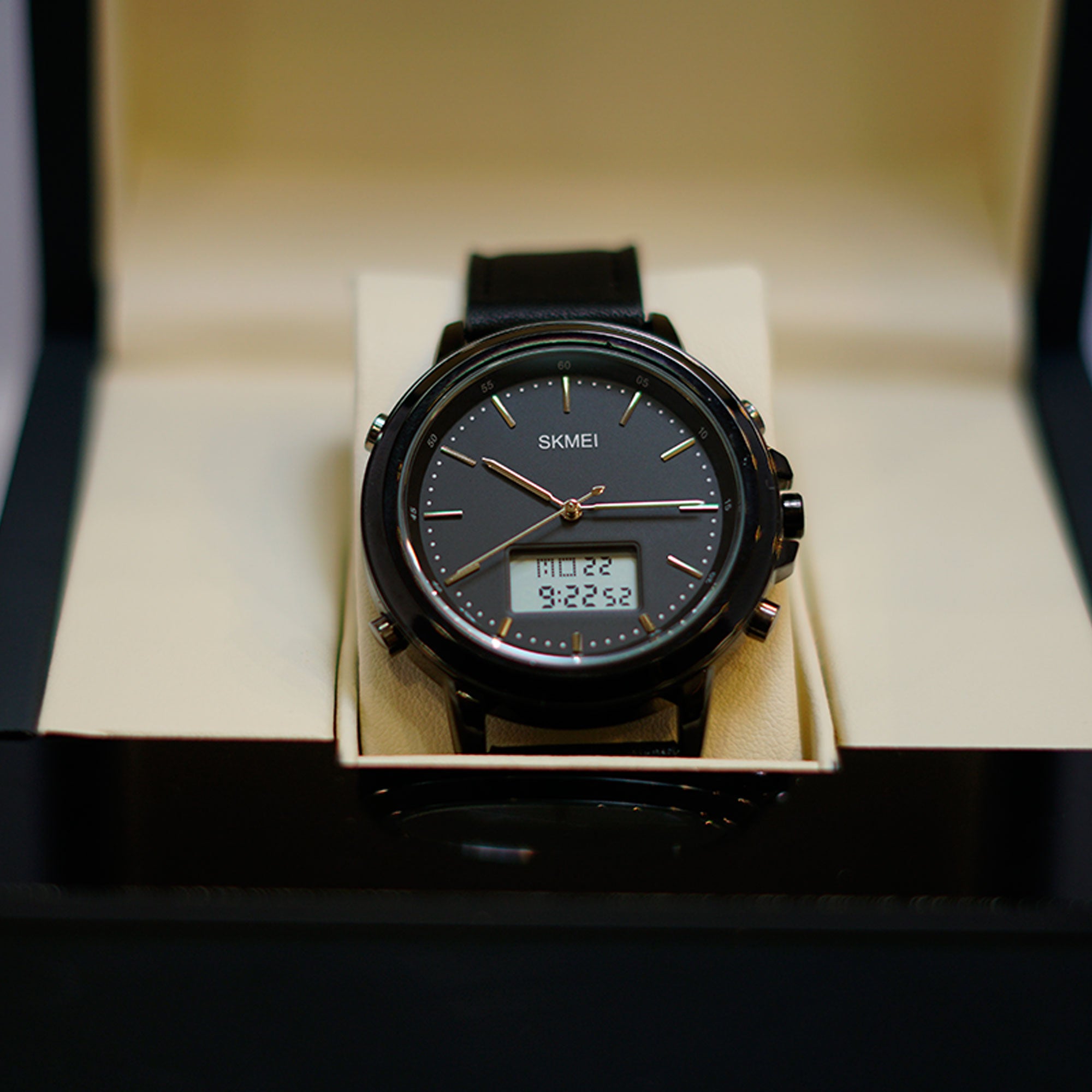 Black digital watch with a SKMEI brand name displayed in an open box.