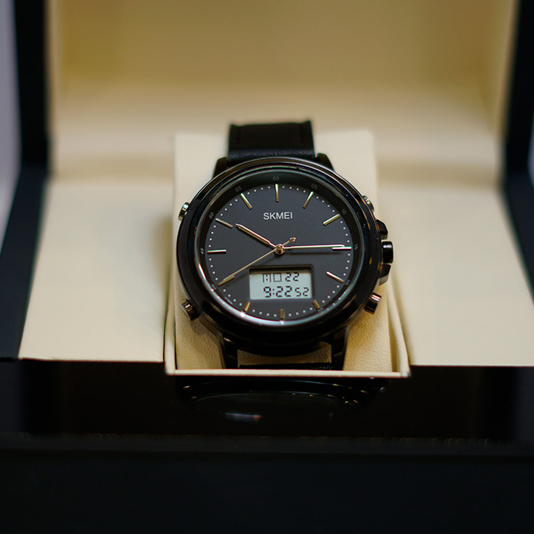 Black digital watch with a SKMEI brand name displayed in an open box.